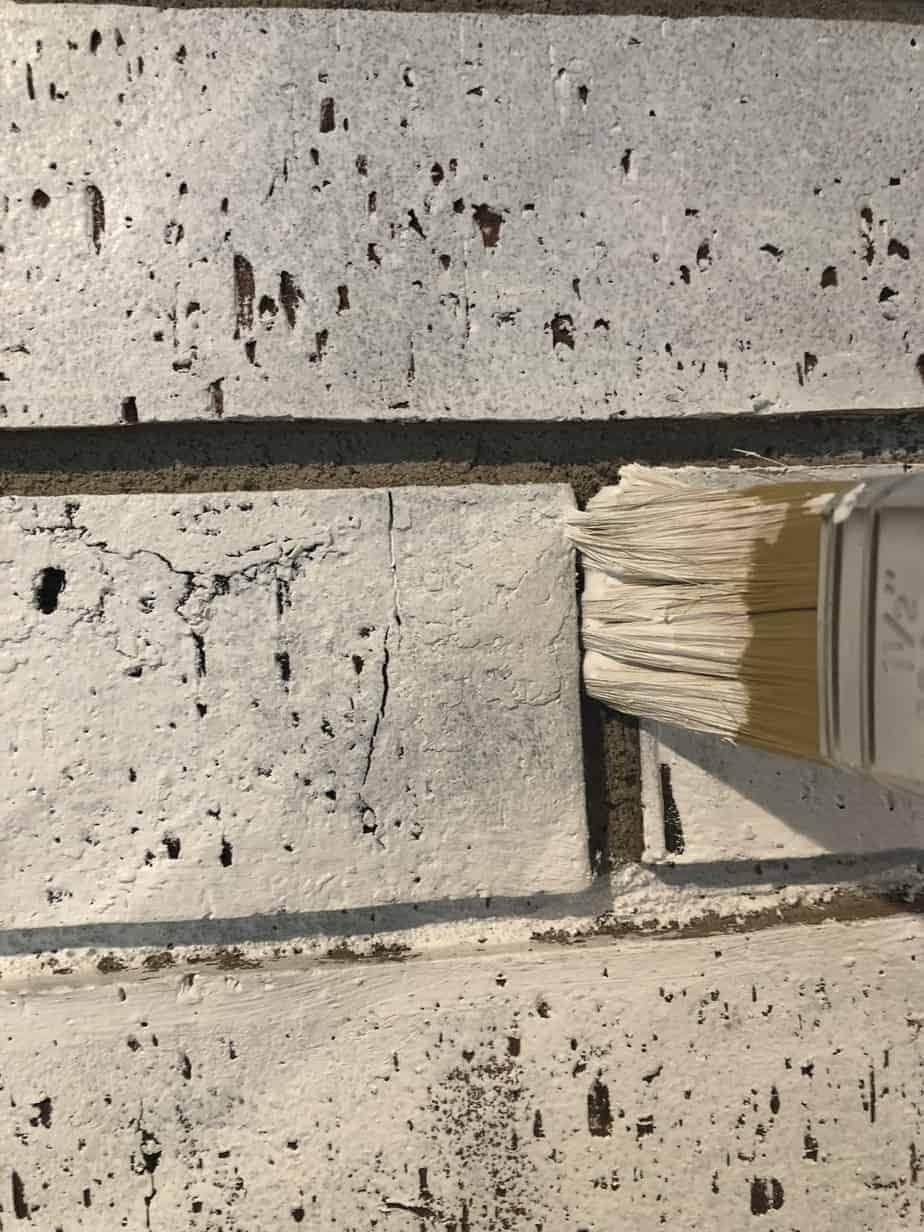 paint brush between bricks