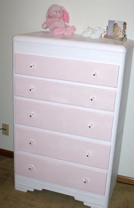 white dresser with pink drawers and glass knobs