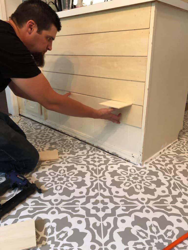 man attaching shiplap boards