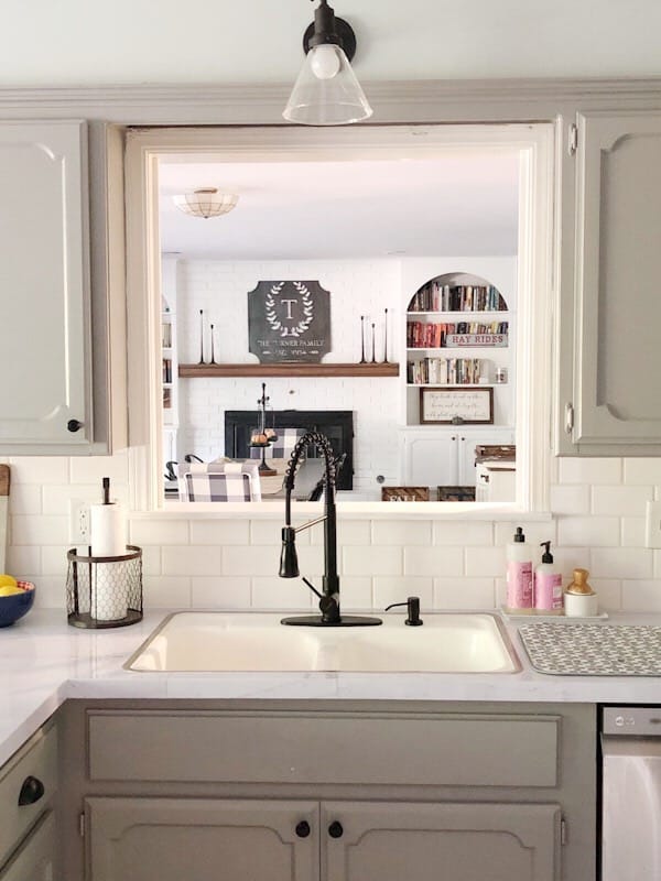 kitchen sink and faucet with view to dining room