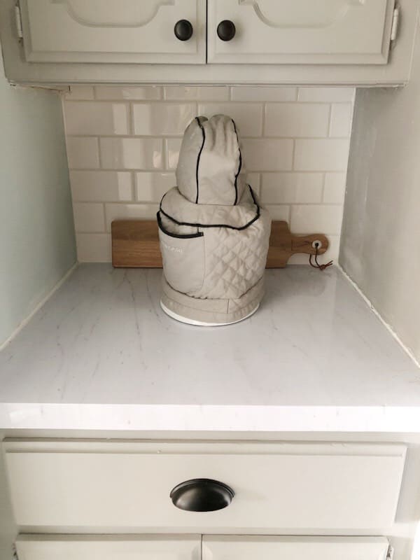 subway tile behind covered mixer