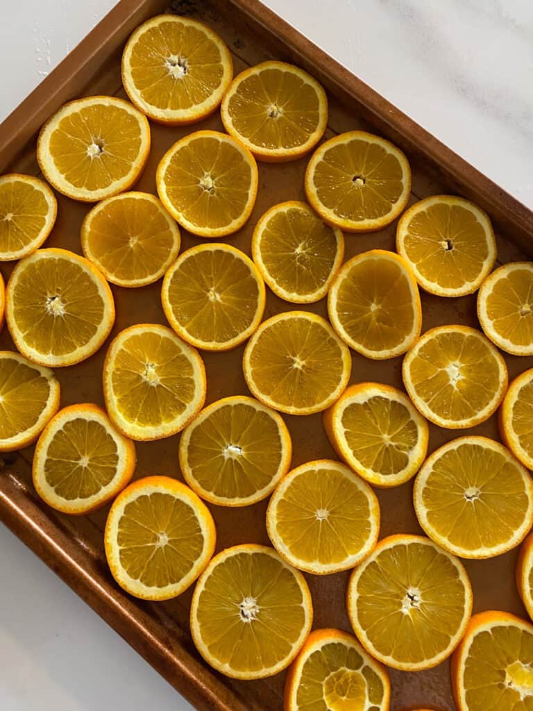 Oranges in single layer on cookie sheet