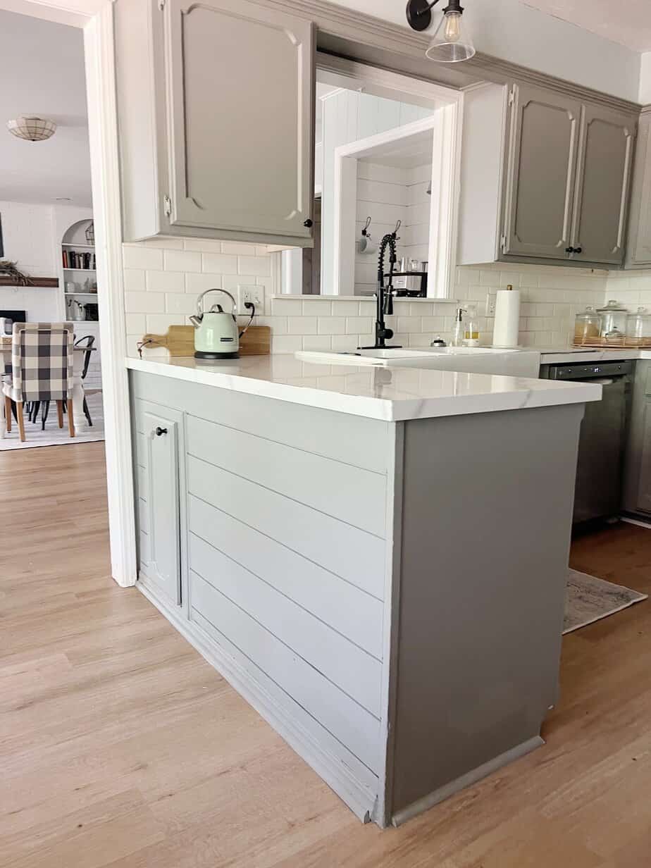 light oak LVP flooring in kitchen with gray cabinets