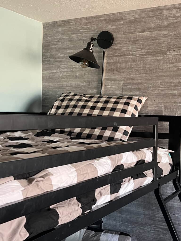 https://doriturnerinteriors.com/wp-content/uploads/2023/01/checkered-beddys-on-black-bunk-beds-768x1024.jpeg