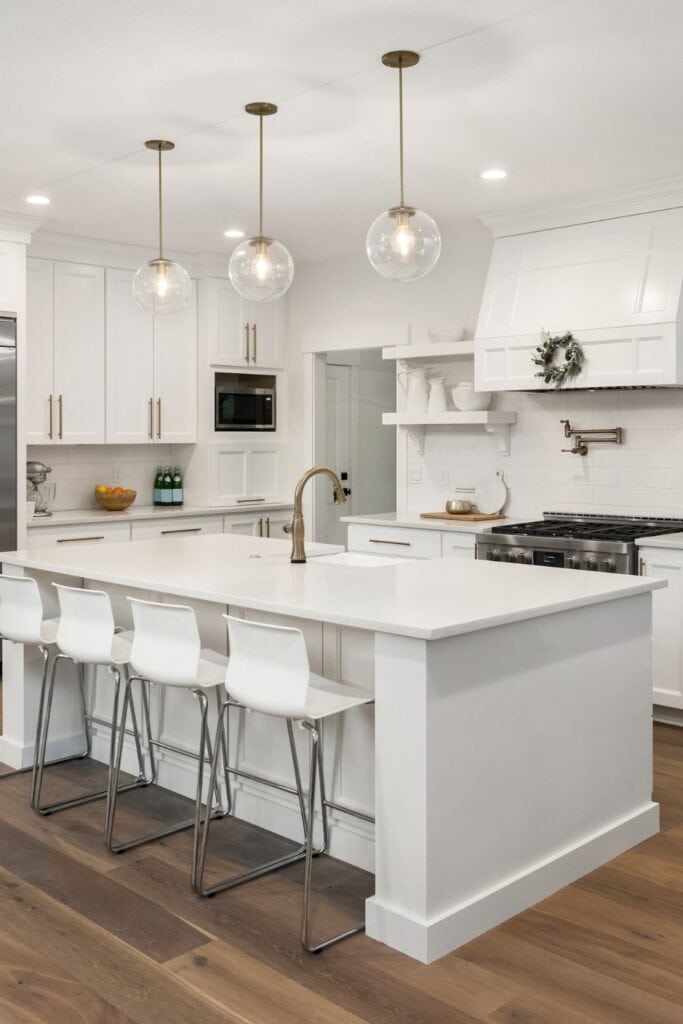 Medium LVP flooring in white traditional kitchen.
