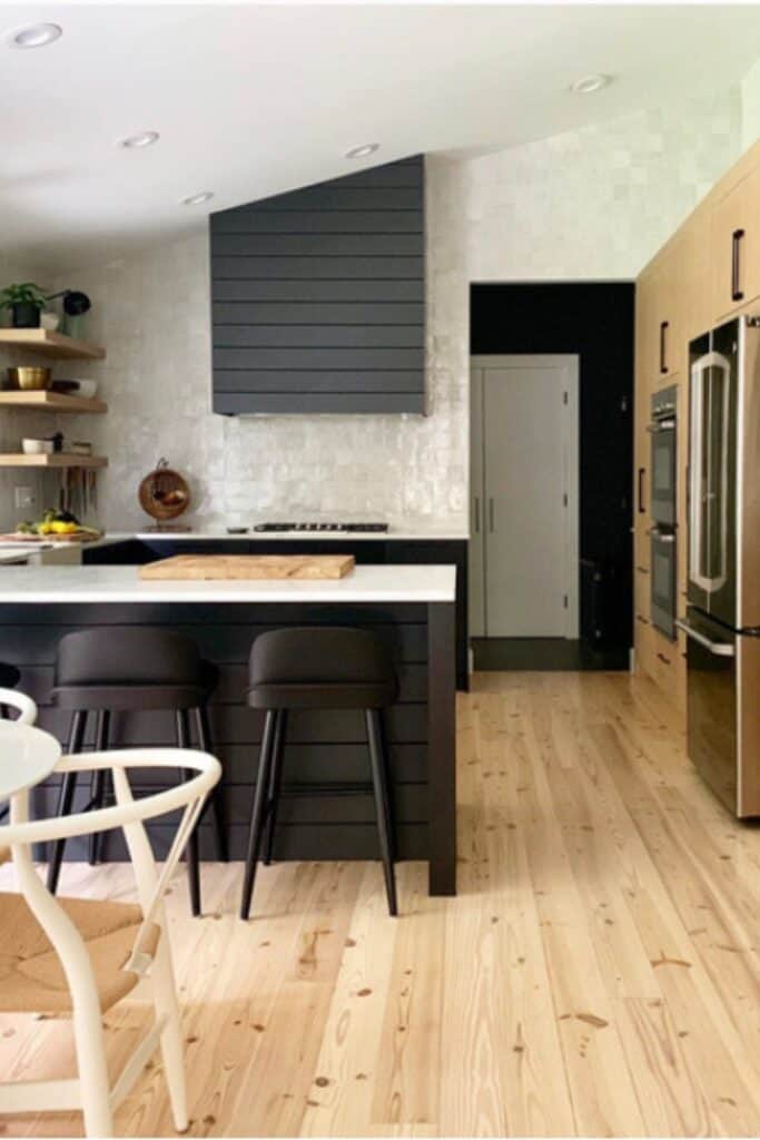 Bright, airy kitchen featuring light hardwood flooring that adds warmth and enhances natural light in the space.