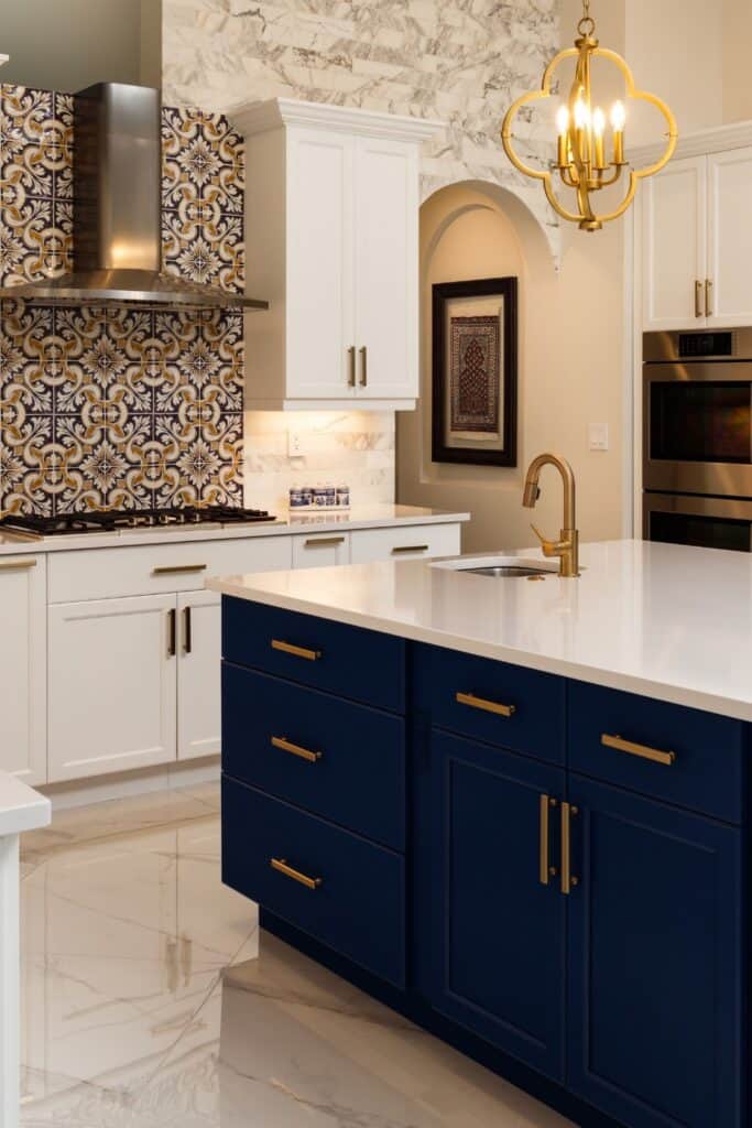 Navy and white kitchen with porcelain tile flooring.
