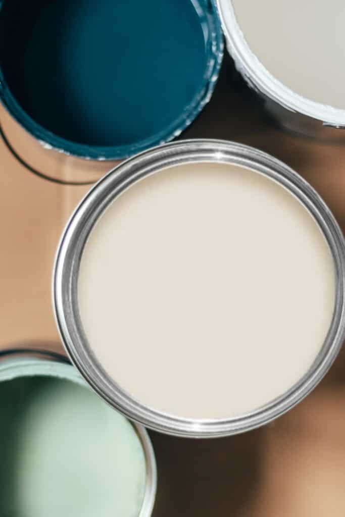 Shoji White Sherwin Williams paint can top with other coordinating colors of white, sage green, and navy