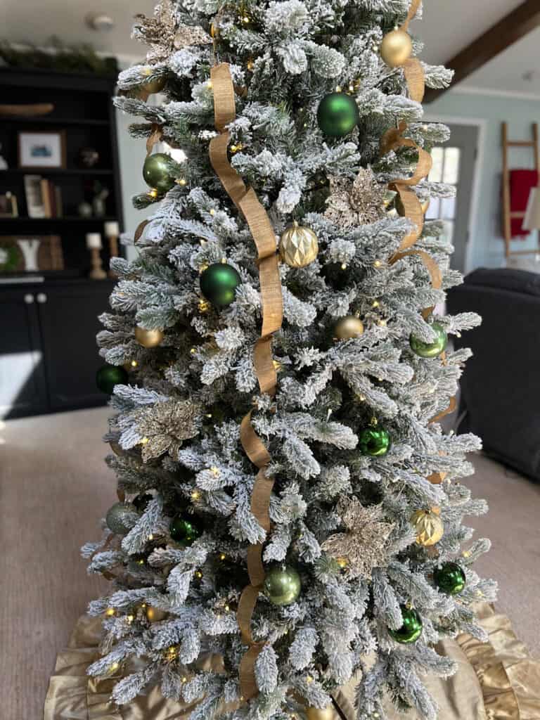 flocked Christmas tree with gold ribbon